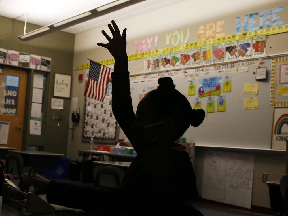 A first-grader raises her hand at Mary L. Fonseca Elementary School in Fall River, Mass., in November.