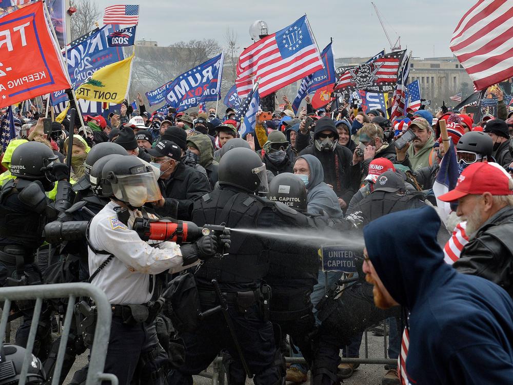 Trump supporters clash with police and security forces as they try to storm the Capitol in Washington, D.C. on Wednesday. Demonstrators breached security and entered the Capitol as Congress debated the 2020 electoral vote certification.