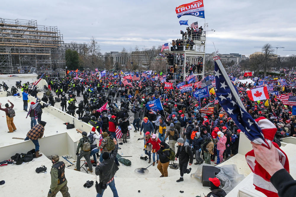 Pro-Trump extremists clash with police and security forces as they invade the inauguration platform.