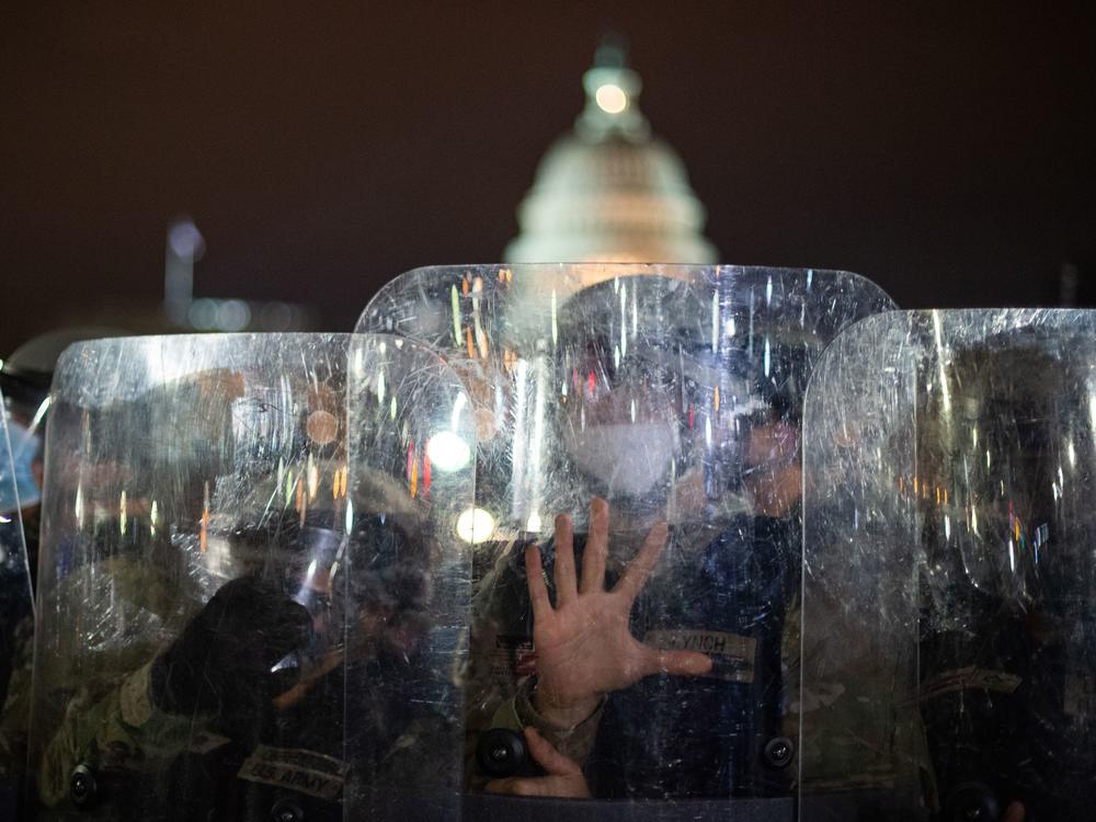 National Guard troops stand behind shields outside the Capitol building in Washington, D.C., on Wednesday evening.