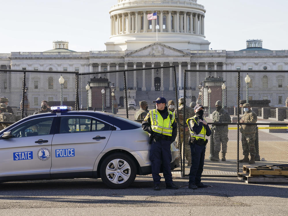 Fencing is placed around the exterior of the Capitol grounds on Thursday, the day after pro-Trump rioters stormed the building. Lawmakers from both parties have criticized the U.S. Capitol Police's response to the security breach.