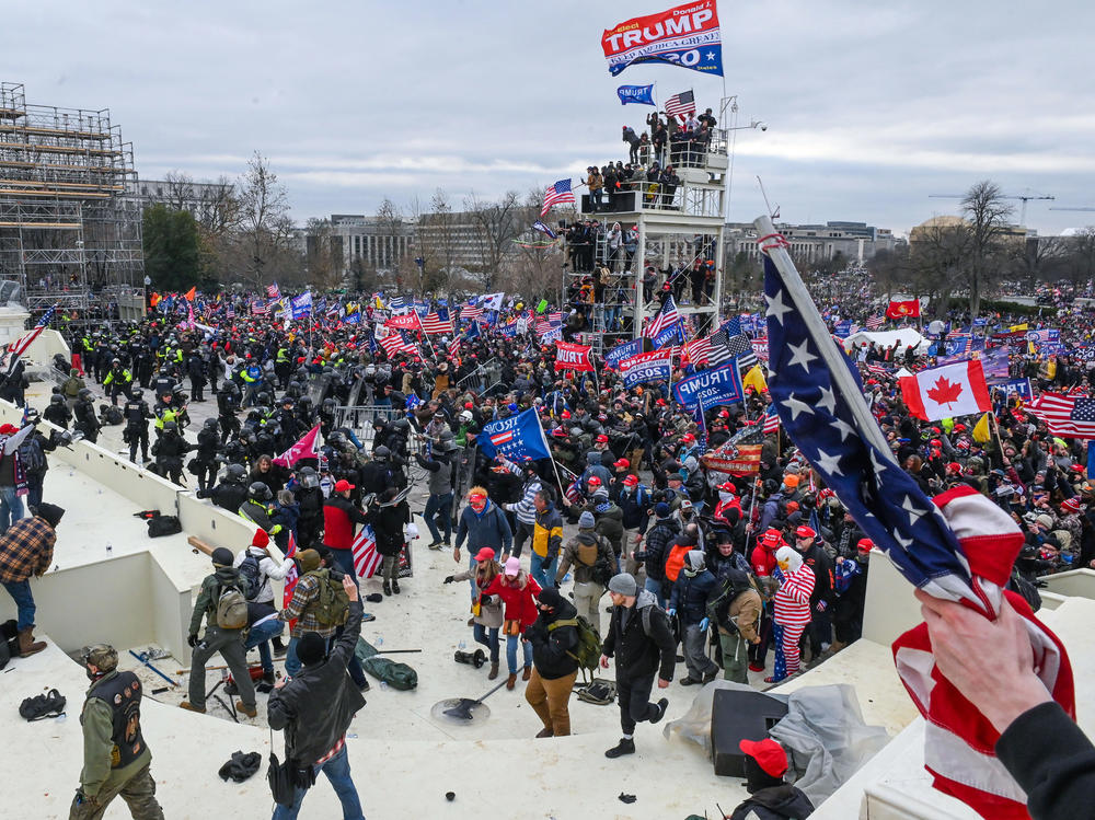 Pro-Trump extremists clash with police and security forces as they invade the Inauguration Day platform on Wednesday. Security forces were quickly overrun as the mob reached the Capitol.