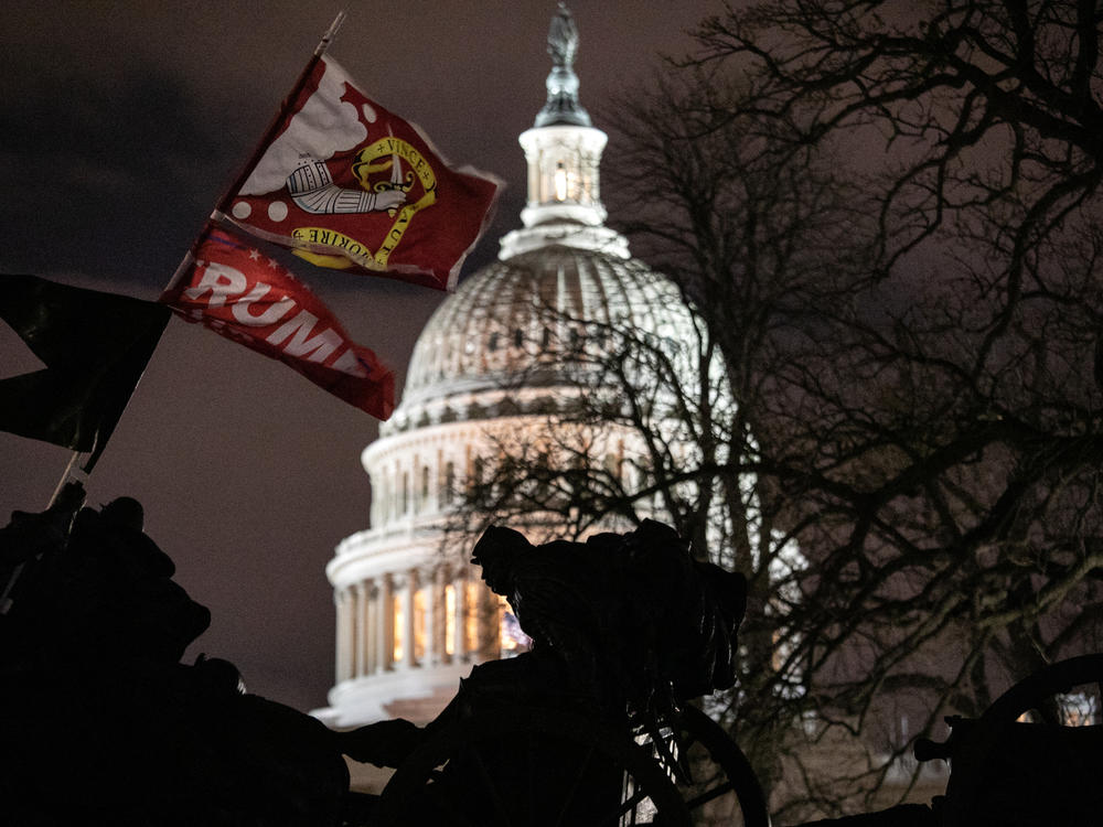 A Trump flag flies over the grounds of the U.S. Capitol on Wednesday after a mob stormed the building, breaking windows and clashing with police officers.