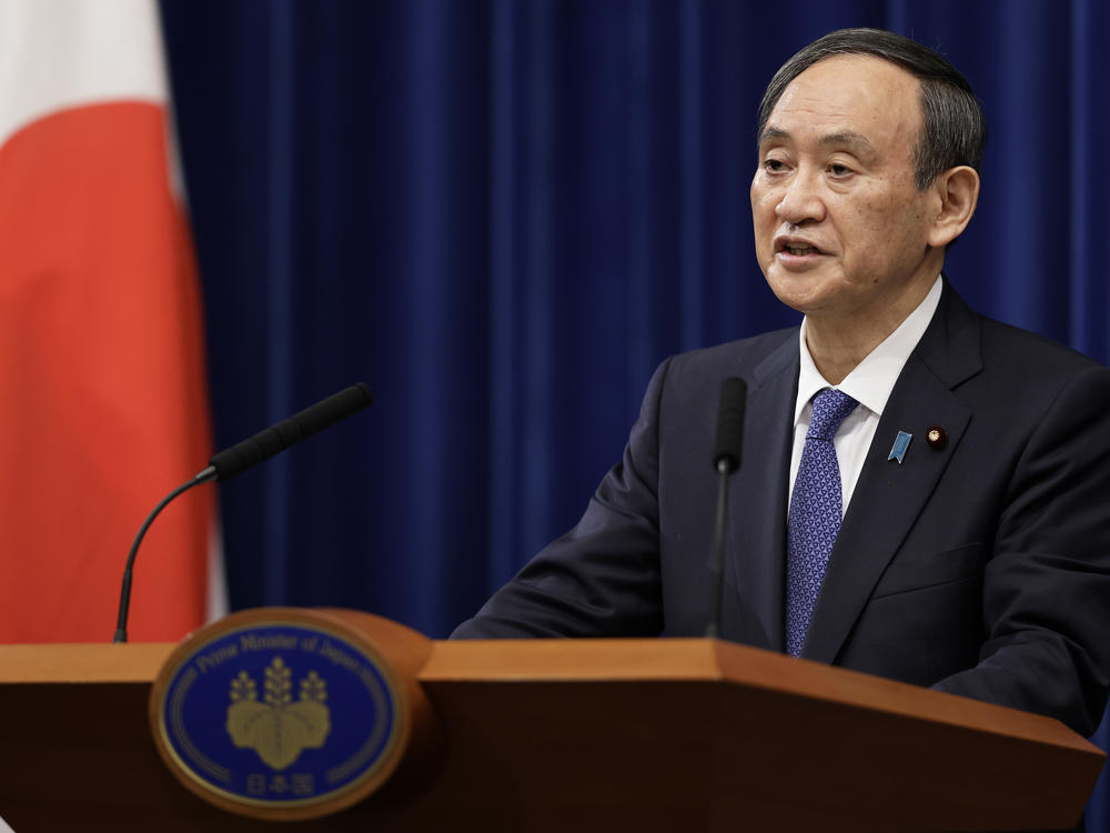 Japan's Prime Minister Yoshihide Suga speaks during a news conference Thursday in Tokyo, where he declared a state of emergency for Tokyo and neighboring prefectures amid a new surge in COVID-19 cases.