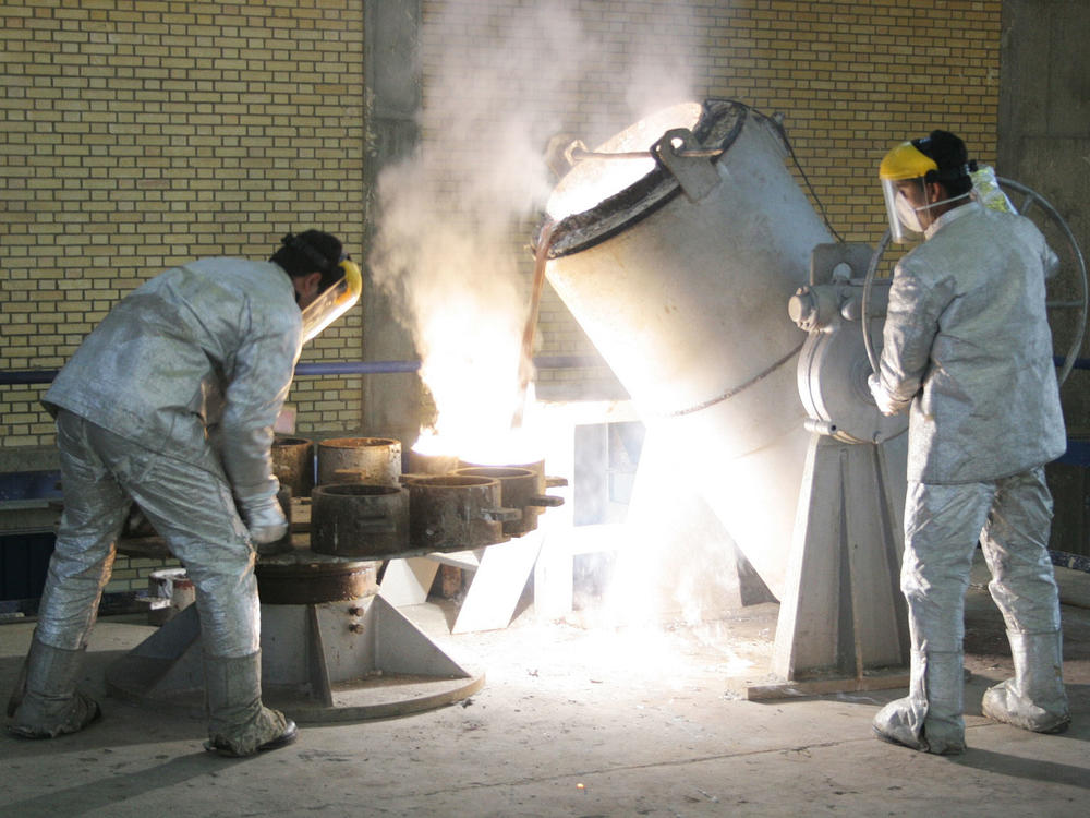 Technicians work inside of a uranium conversion facility producing unit in 2005 outside the city of Isfahan, Iran. After the 2015 Iran nuclear deal put limits on the program, Iran's government has been increasing uranium enrichment since the United States pulled out of deal.