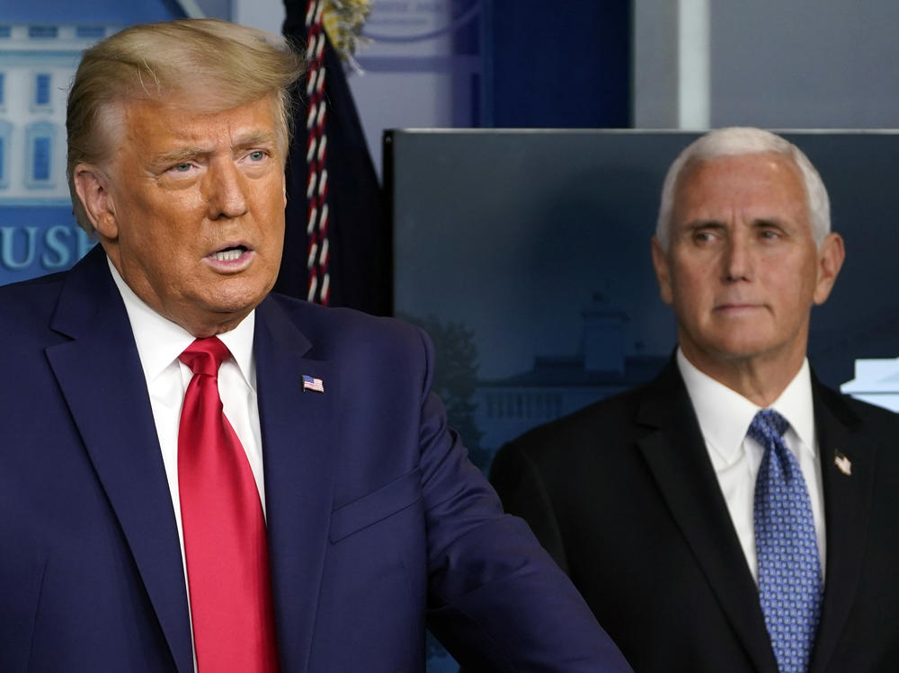 President Trump speaks in the press briefing room in November as Vice President Pence listens behind him.