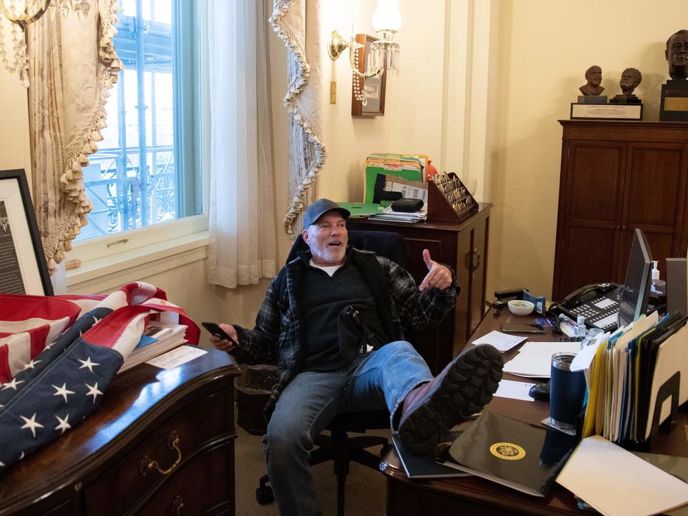 Richard Barnett has been arrested in his home state of Arkansas and faces charges related to his part in the forced entry into the Capitol. During the riot, Barnett sat in House Speaker Nancy Pelosi's office.