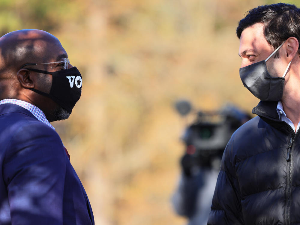 Georgia Sens.-elect Rev. Raphael Warnock (left) and Jon Ossoff before a campaign stop on Jan. 4. While the pair ran as a ticket, Warnock garnered nearly 20,000 more votes, in part due to many conservative voters' concerns about Warnock's GOP opponent, Sen. Kelly Loeffler.