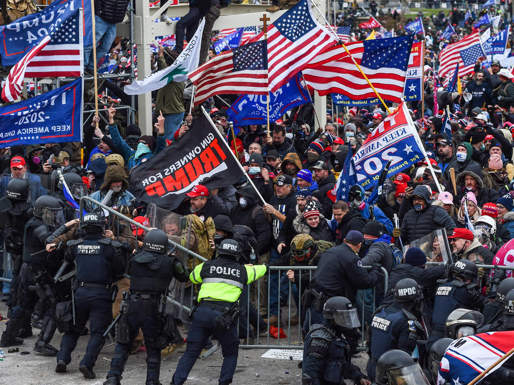 Police and security forces attempt to hold back a mob of pro-Trump extremists as they storm the U.S. Capitol in Washington on Wednesday.