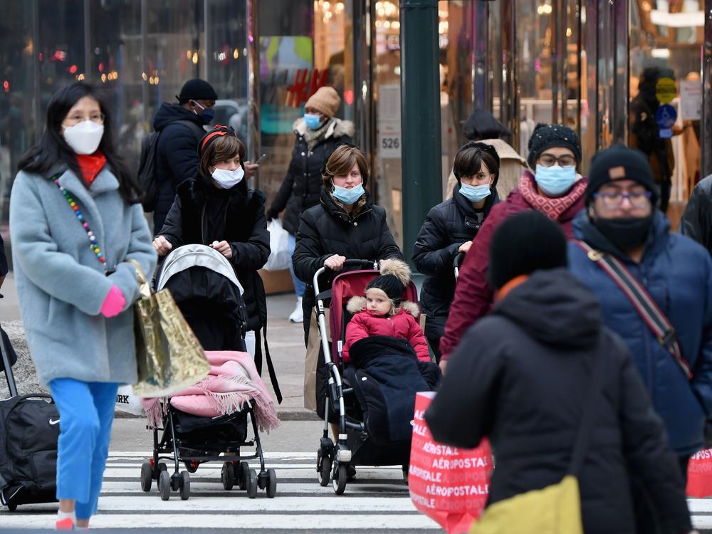 People walk through a busy shopping area amid the coronavirus pandemic on Jan. 5 in New York City. Coronavirus cases are up in almost every state.