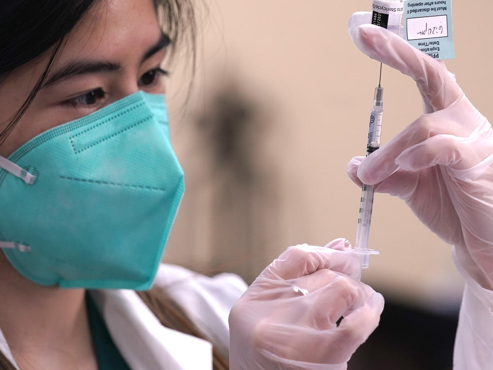 Skepticism about COVID-19 vaccinations has prompted suggestions that the government should pay people to get the shots. (AP Photo/LM Otero)