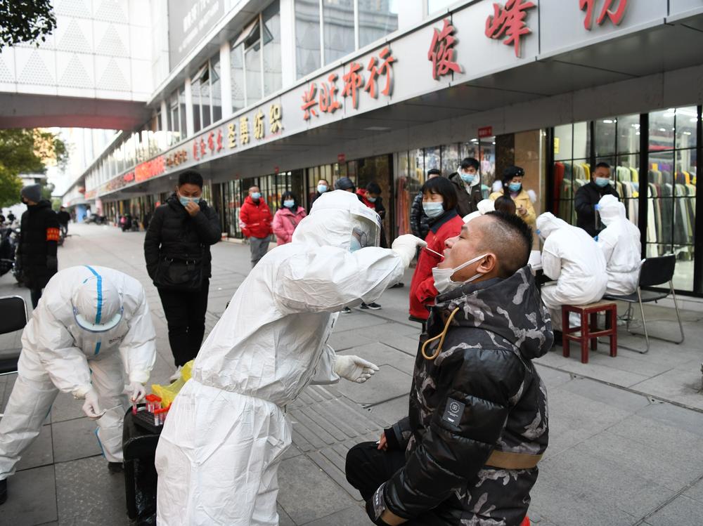 People queue up for nucleic acid testing at Hanzheng Street wholesale market on Tuesday, in Wuhan, Hubei Province of China.