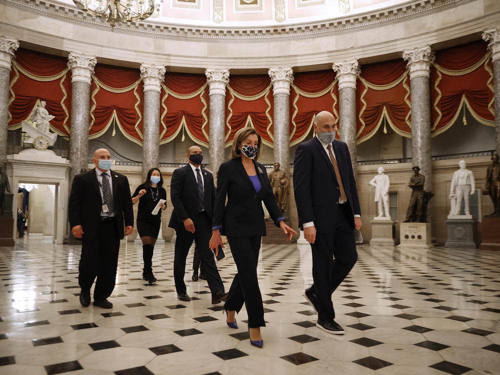 House Speaker Nancy Pelosi, D-Calif., heads to the House Chamber at the U.S. Capitol Tuesday. The House is debating whether to impeach President Trump a second time on Wednesday.