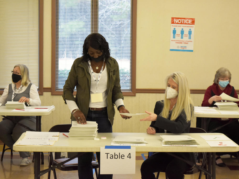 Bartow County, Ga. election workers conduct a full hand count of ballots in the Jan. 5 Senate runoff between former Sen. David Perdue and Sen.-elect Jon Ossoff as part of a voluntary recount aimed at improving voter confidence.