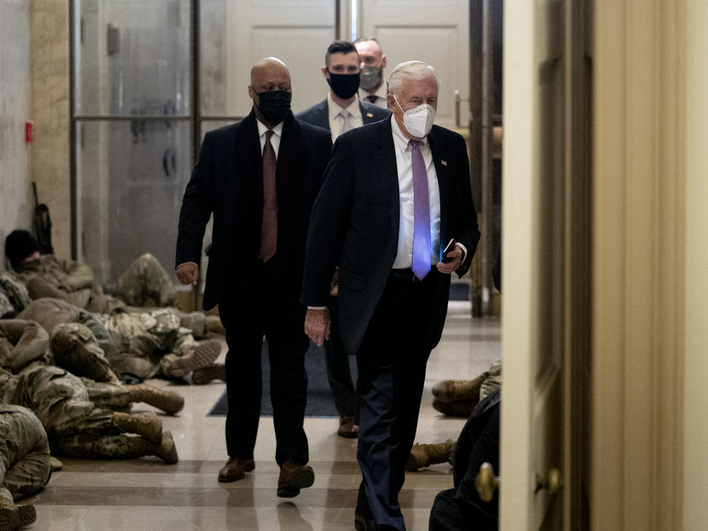 House Majority Leader Steny Hoyer, D-Md., passes some of the security forces who have been called up to protect the U.S. Capitol on Wednesday as the House impeachment proceedings begin.
