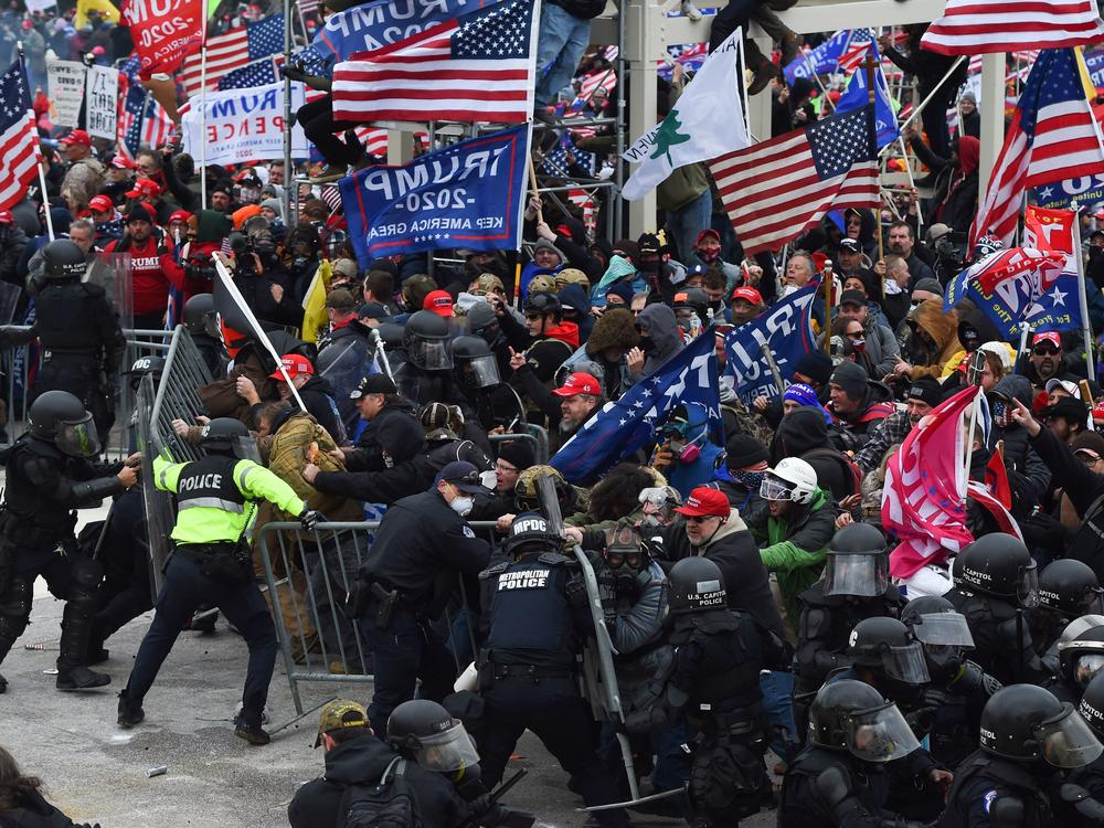 Trump supporters clash with police and security forces as they push down barricades to storm the U.S. Capitol on Jan. 6.