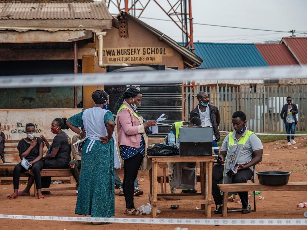 Ugandan election commission officials count ballots after the polls closed at a polling station in Kampala on Thursday.
