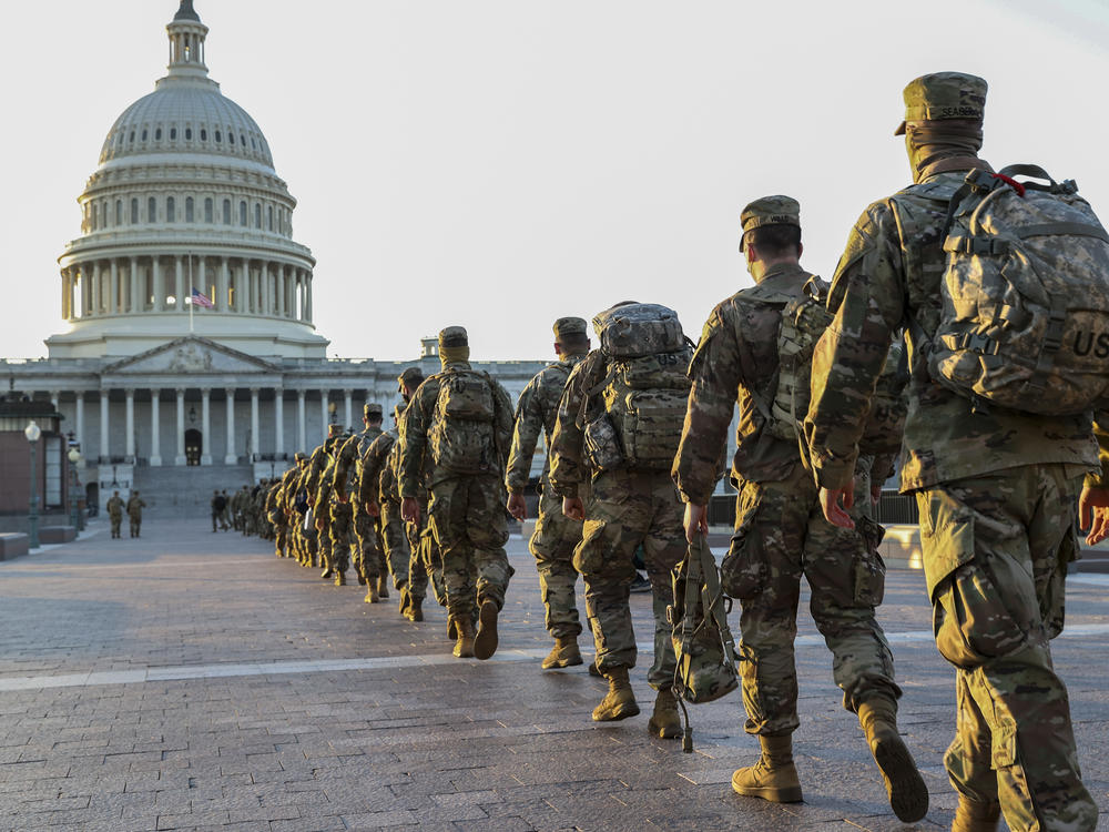 Members of the National Guard arrive at the U.S. Capitol on Tuesday. Following the insurrection on Jan. 6, 20,000 National Guard troops are expected to be involved in securing President-elect Joe Biden's inauguration next week.