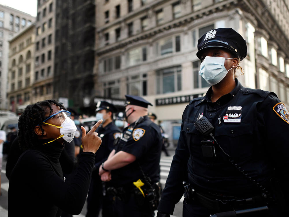 Shouting protesters face NYPD officers during a Black Lives Matter demonstration last summer in New York City, in outrage over the death of a Black man in Minnesota who died after a white policeman knelt on his neck for several minutes.