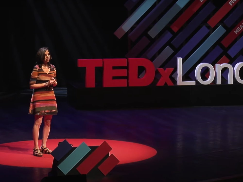 Beth Gardiner speaks on the TEDx stage in London.