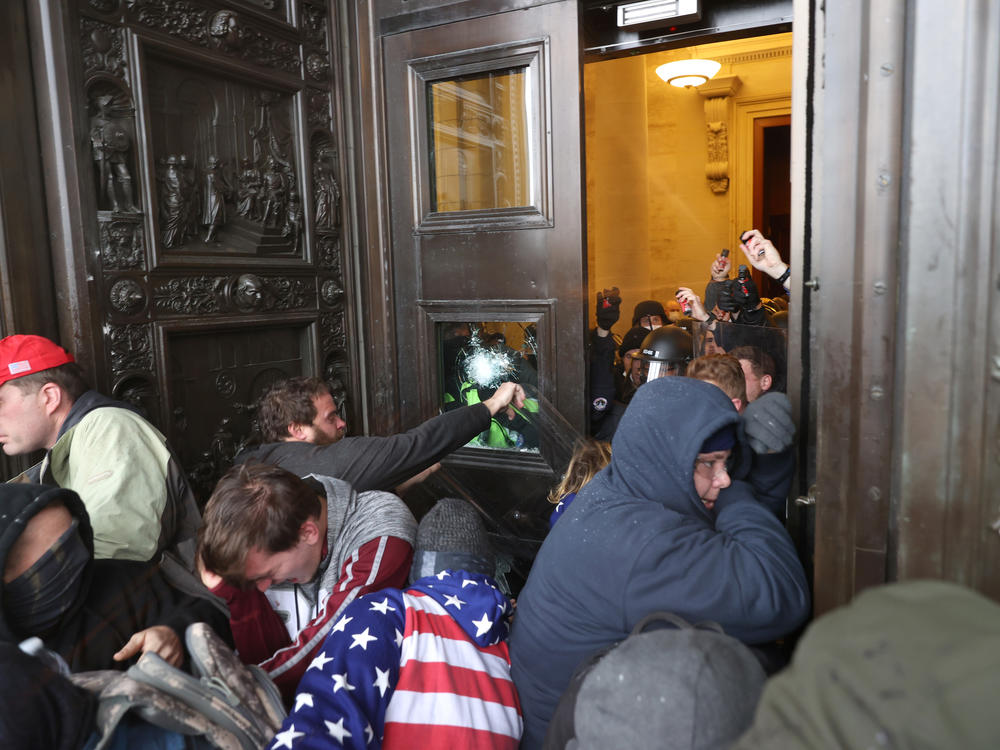 Protesters break windows and attempt to enter the U.S. Capitol Building.
