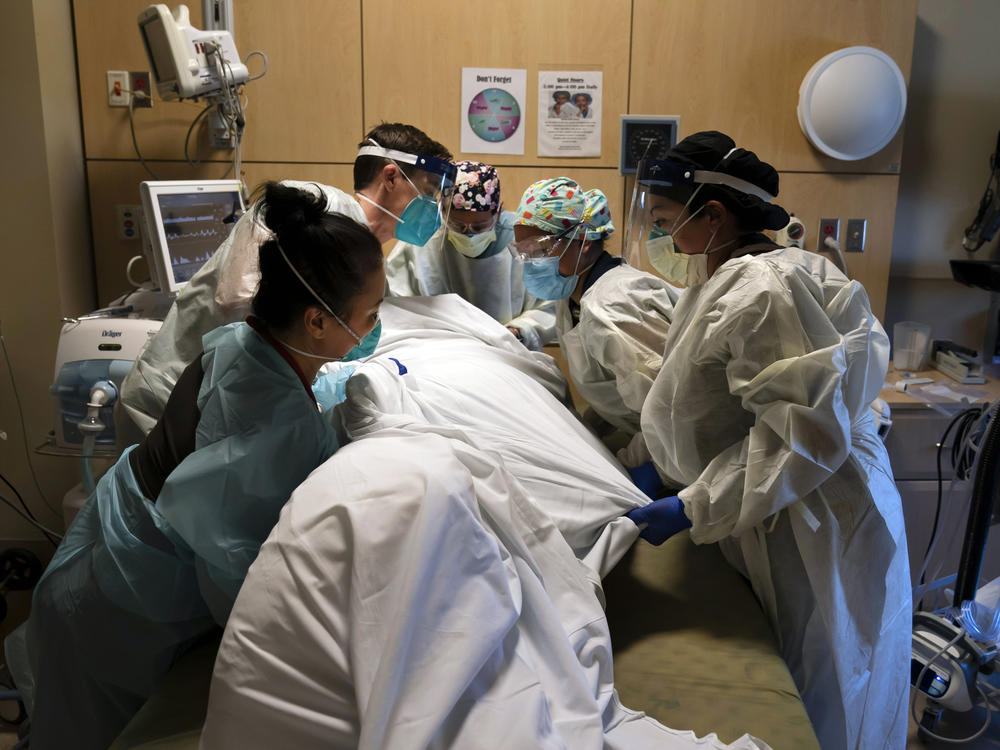 Medical personnel prone a COVID-19 patient last November at Providence Holy Cross Medical Center in the Mission Hills section of Los Angeles.