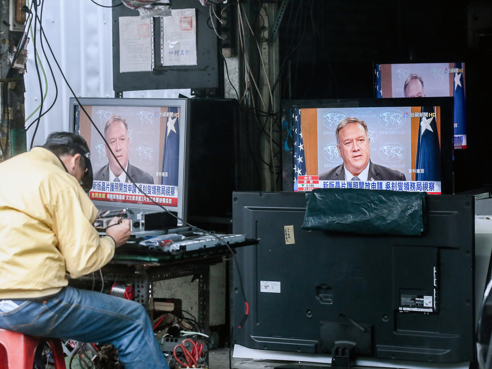 Televisions show a news broadcast of U.S. Secretary of State Mike Pompeo in Taipei, Taiwan, on Jan. 11. The Trump administration removed decades-old restrictions on interactions with Taiwanese officials just days before President-elect Joe Biden's inauguration.