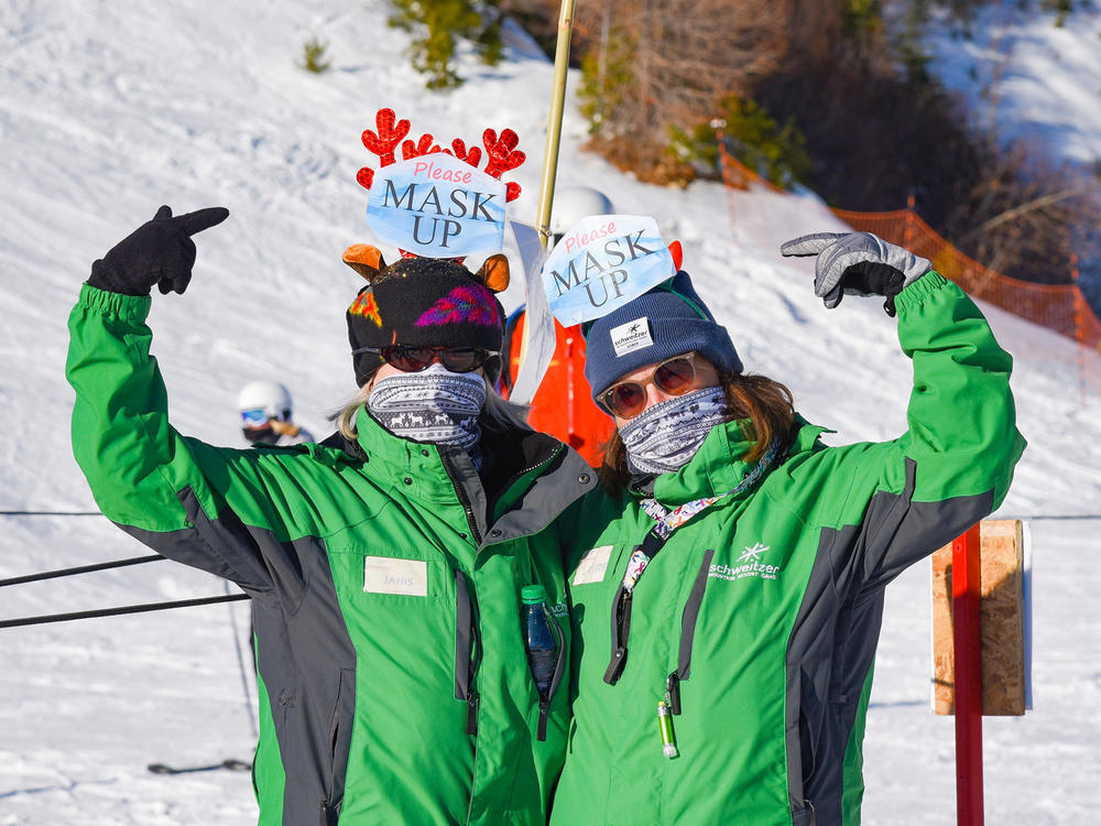 Lift line attendants at Schweitzer Mountain remind skiers and boarders to wear their masks. The ski area's president Tom Chasse says, 