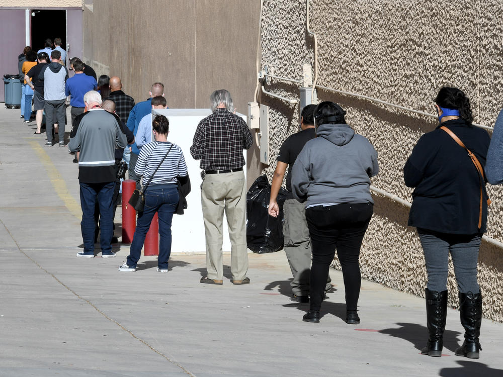 People line up on Thursday for the first day of Clark County's pilot COVID-19 vaccination program at Cashman Center in Las Vegas.