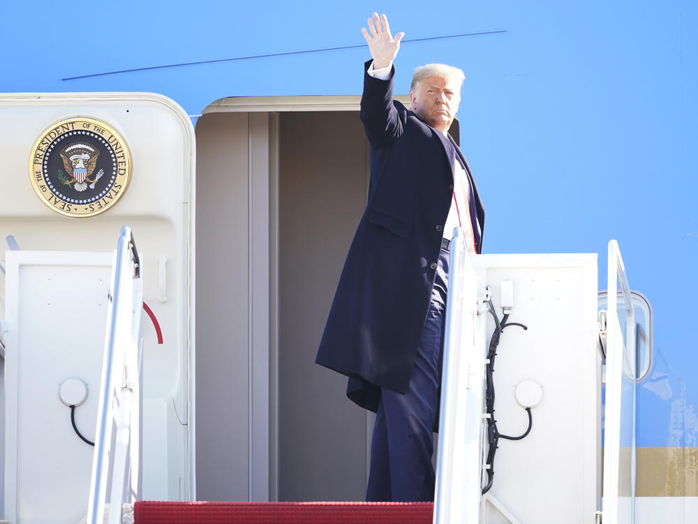 President Trump waves while boarding Air Force One at Joint Base Andrews before a Jan. 12 trip. He's planning a departure ceremony there on Wednesday, while skipping the traditional send-off at the Capitol.