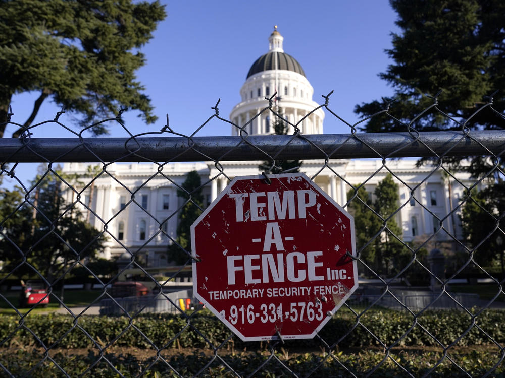 A temporary 6-foot-high chain-link fence now surrounds California's state Capitol. Gov. Gavin Newsom said Thursday, 