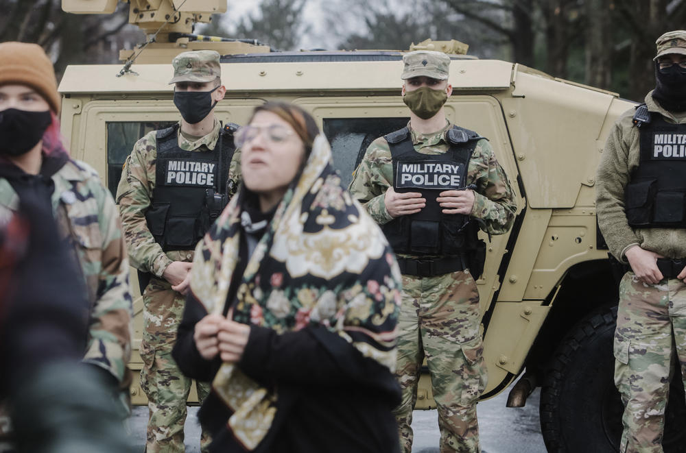 A demonstrator shouts slogans in front of members of the National Guard outside the Kentucky State Capitol in Frankfort, Kentucky.