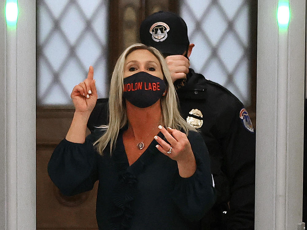 Rep. Marjorie Taylor Greene, R-Ga., yells at journalists after setting off the metal detector outside the doors to the House of Representatives Chamber on Jan. 12. Twitter suspended the newly elected lawmaker's account temporarily on Sunday.