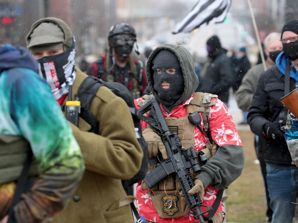 Armed demonstrators protest outside of the Michigan state capital building on Sunday in Lansing, Michigan.