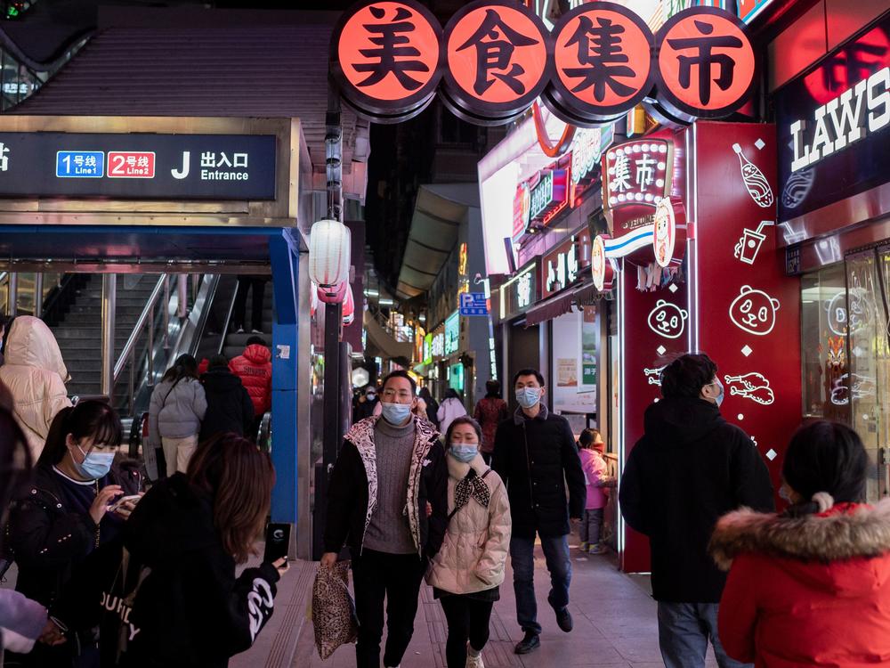 People walk in Wuhan on Jan. 10, the eve of the first anniversary of China confirming its first COVID-19 death. Chinese officials said on Monday that its economy managed to grow 2.3% in 2020.