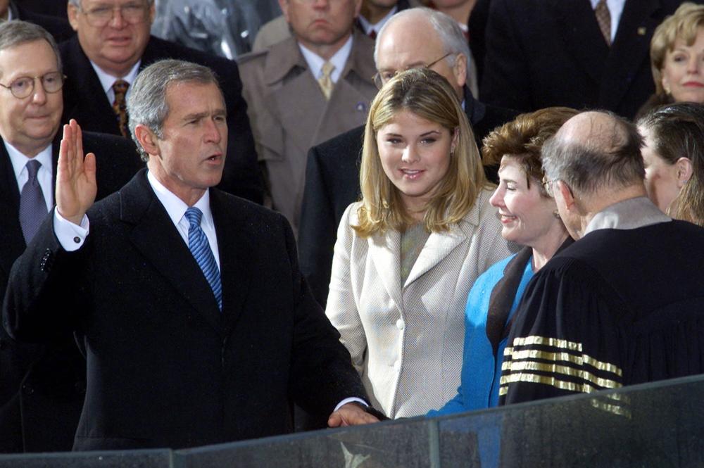 George W. Bush takes the oath of office from Chief Justice William Rehnquist to become the 43rd president on Jan. 20, 2001, in Washington. Wife Laura Bush holds the Bible beside daughter Jenna.