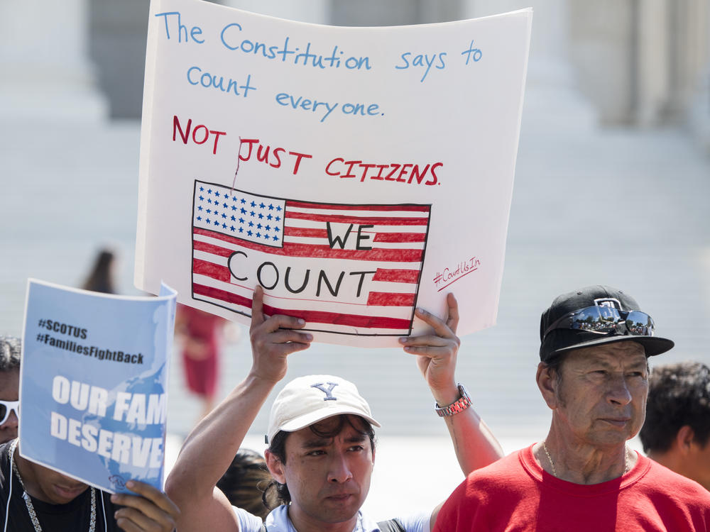 Protesters hold signs at a rally about the 2020 census in front of the U.S. Supreme Court in 2019. President-elect Joe Biden has revoked the Trump administration's policy of excluding unauthorized immigrants from population numbers used to reallocate congressional seats and Electoral College votes.