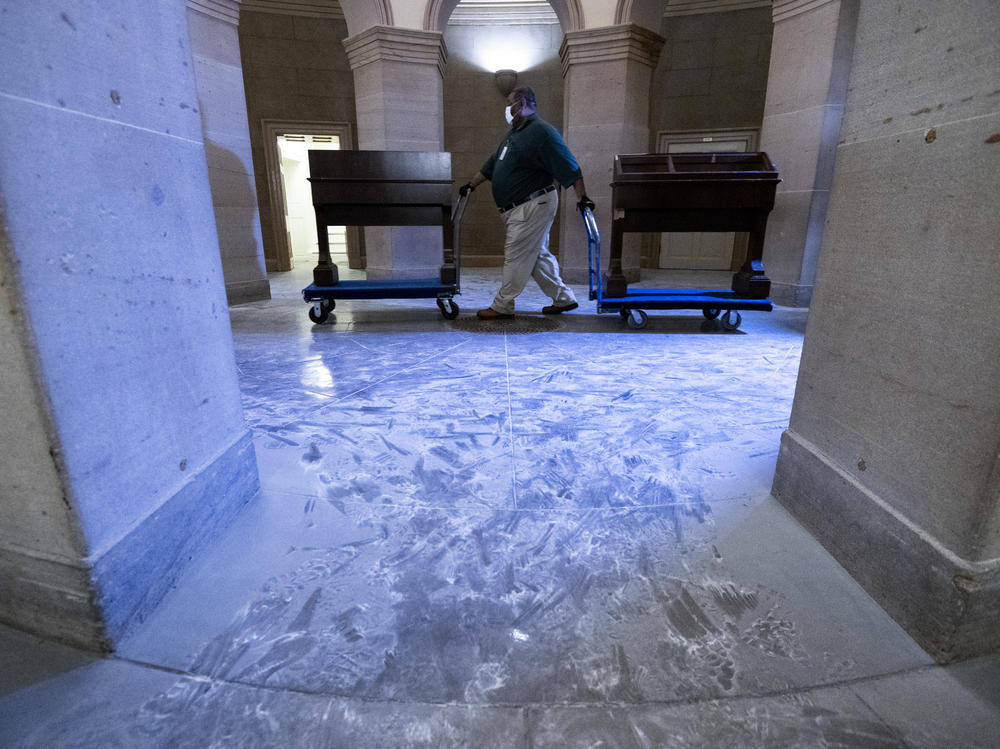 Capitol workers remove damaged furniture on from the U.S. Capitol on January 7, 2021, following the riot at the Capitol the day before.