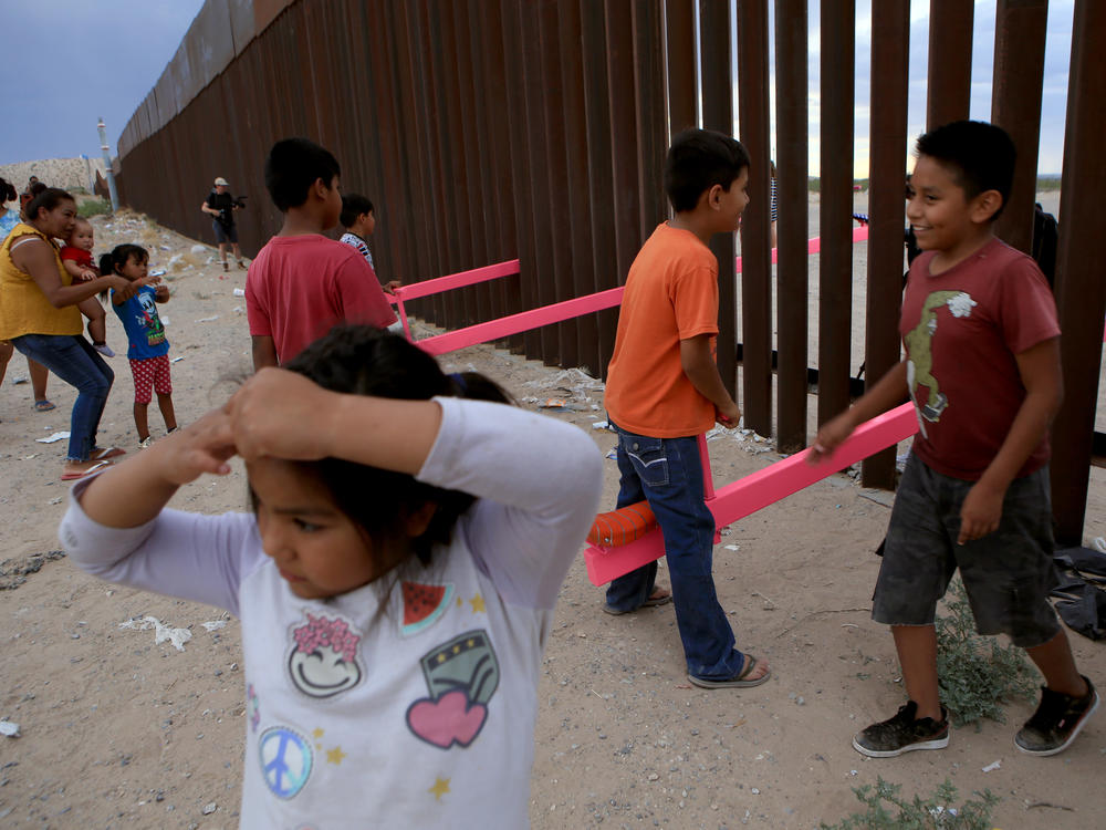 American and Mexican families play with a seesaw installation at the border near Ciudad Juarez, Mexico, in July 2019. London's Design Museum recognized the project with an award for best design of 2020.