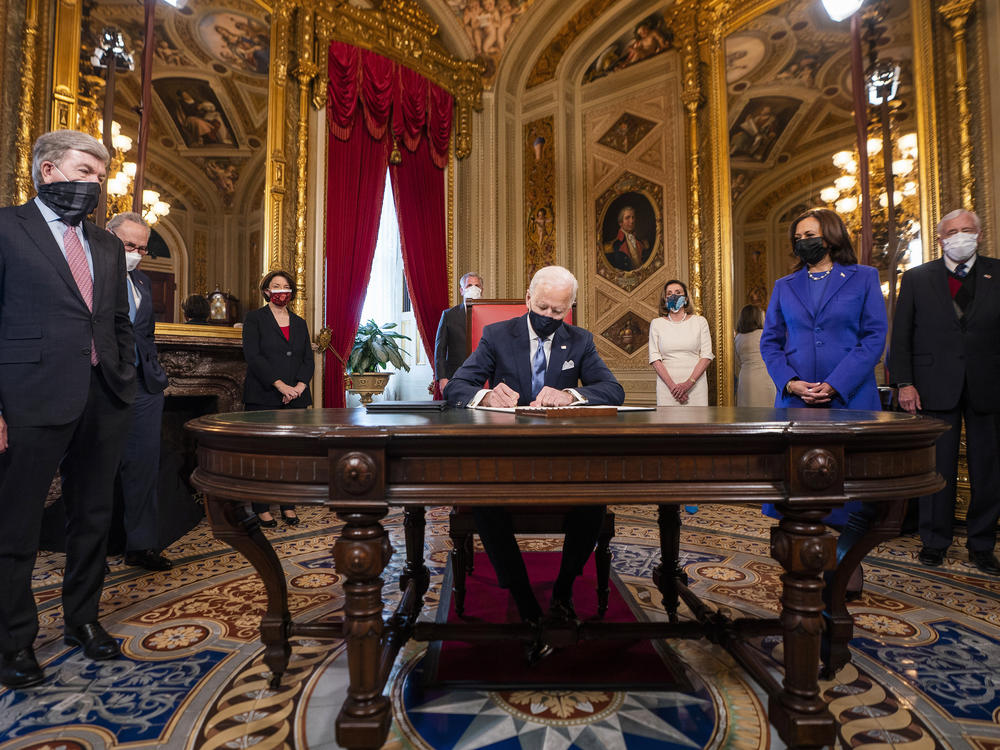 President Joe Biden signs three documents including an inauguration declaration, cabinet nominations and sub-cabinet nominations in the President's Room at the US Capitol after the inauguration ceremony, Wednesday.