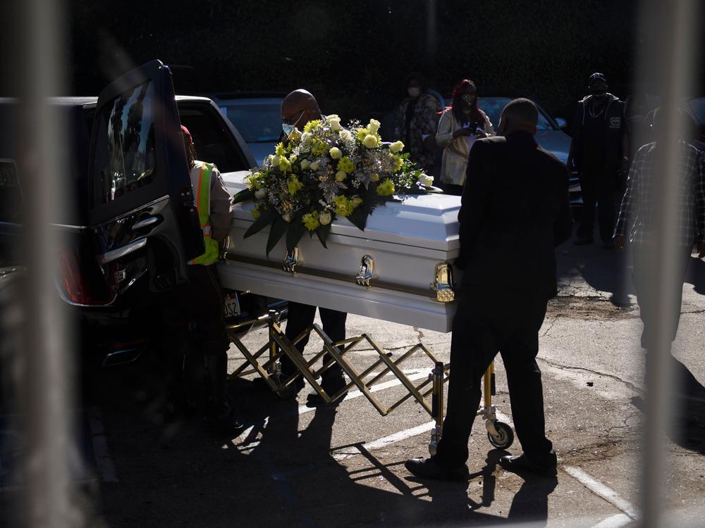 A casket is loaded into a hearse at the Boyd Funeral Home as burials at cemeteries are delayed to the surge of COVID-19 deaths on Jan. 14, 2021 in Los Angeles.