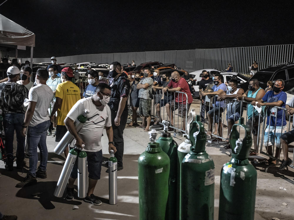 Workers check oxygen tanks at a hospital in Manaus, Brazil. Severe oxygen shortages as a second coronavirus wave is surging have prompted local authorities to airlift patients to other parts of Brazil.