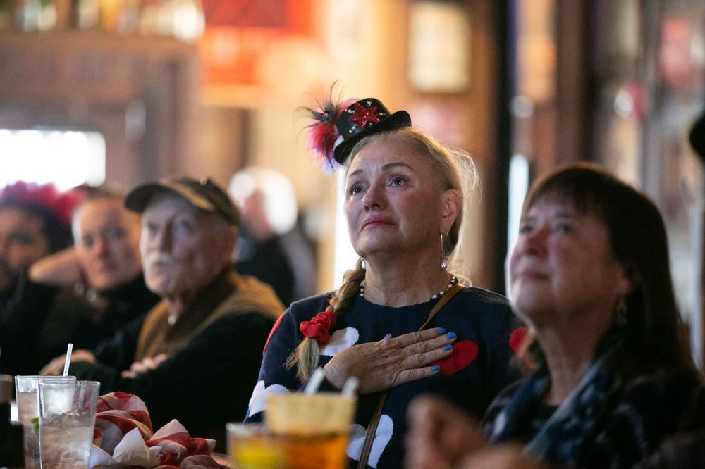 Kelsey Nix watches a television airing the Inauguration Day ceremony at Manuel's Tavern in Atlanta.