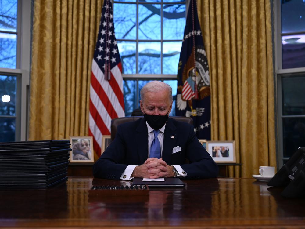 President Biden sits in the Oval Office at the White House after being sworn in as the 46th president of the United States on Wednesday.