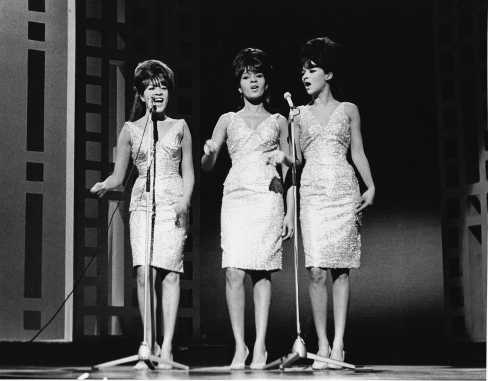 The Ronettes (left to right: Veronica Bennett, Estelle Bennett an Nedra Talley) on stage in 1963, the year they signed with Phil Spector and recorded and released 