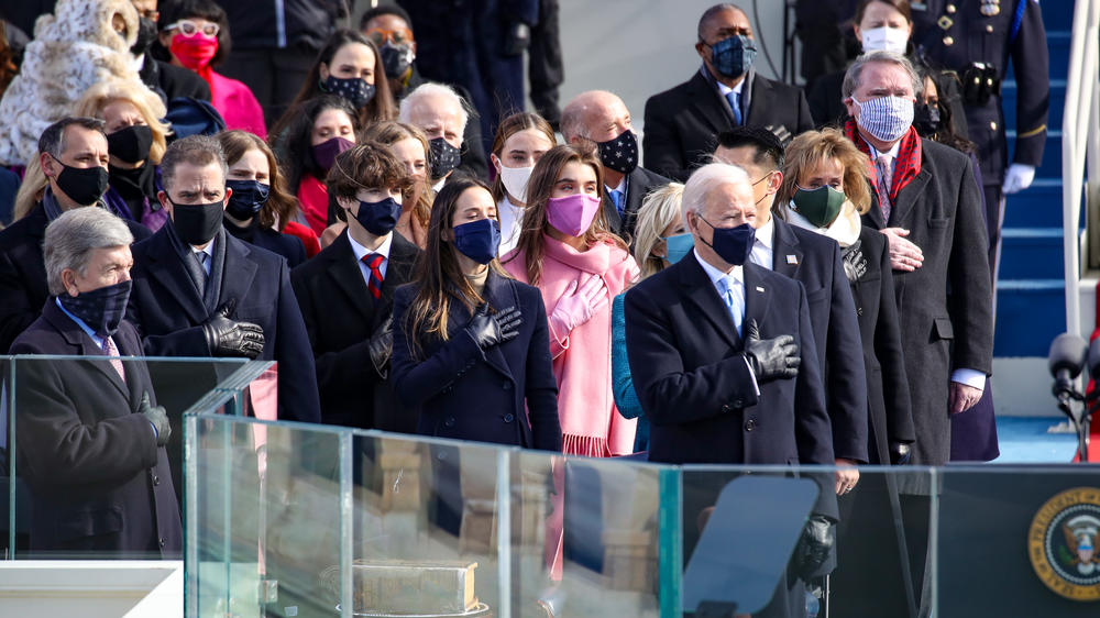 President-elect Joe Biden and invited guests stand for the national anthem and the Pledge of Allegiance at the inauguration ceremony on the West Front of the U.S. Capitol on Wednesday.