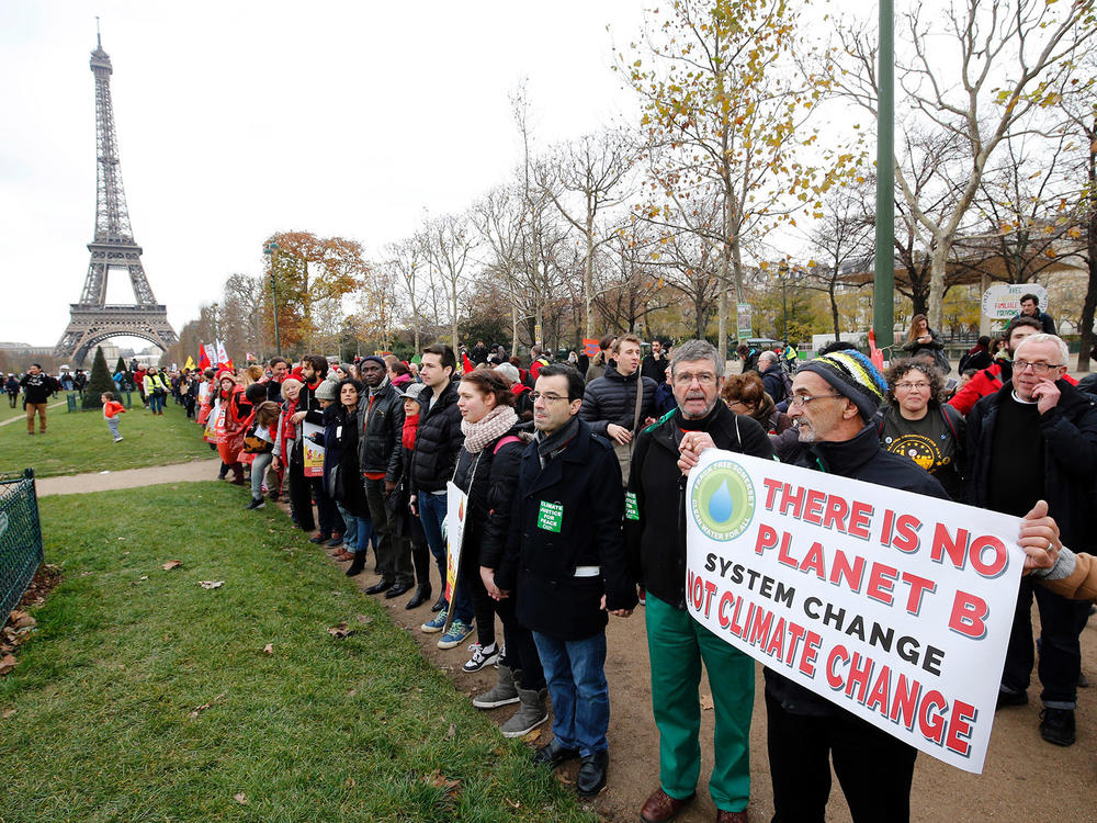 President Joe Biden is directing the U.S. to rejoin the international Paris Climate Agreement, which aims to cut global greenhouse gas emissions. Here, activists rally on Dec. 12, 2015.