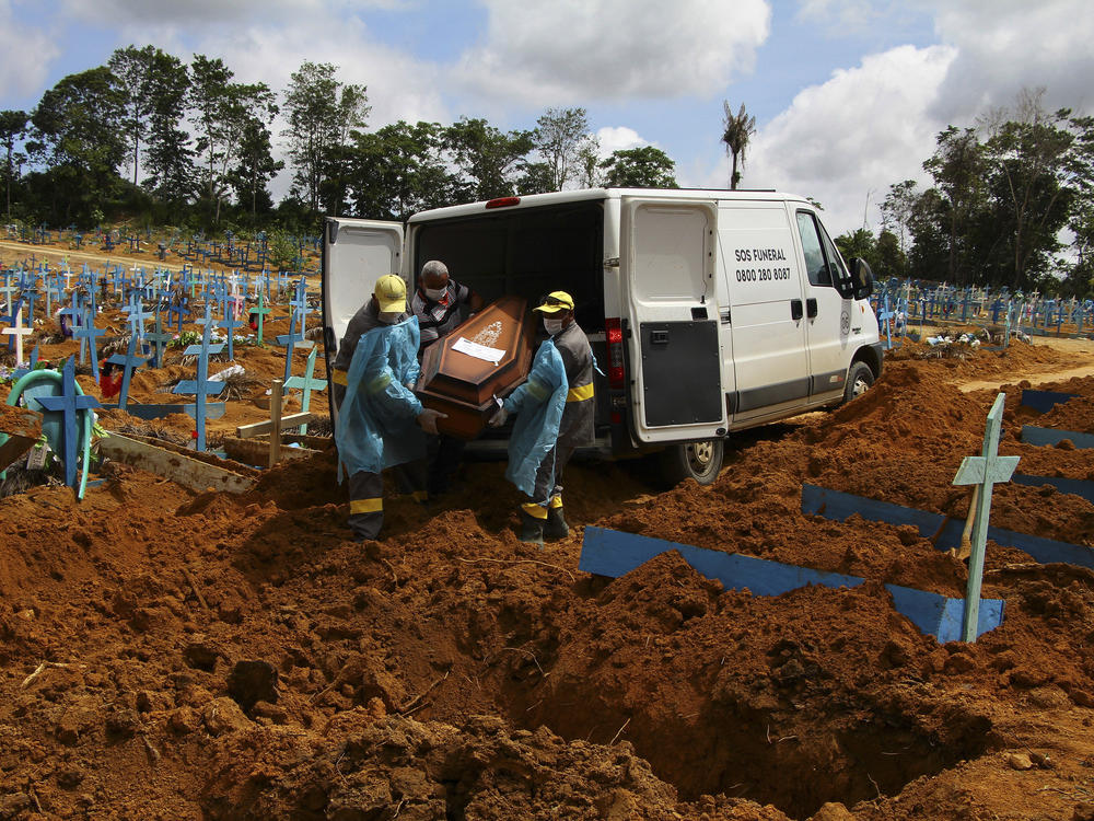 Cemetery workers carry the remains of 89-year-old Abilio Ribeiro, who died of the new coronavirus, for burial at the Nossa Senhora Aparecida cemetery in Manaus, Amazonas state, Brazil, on Jan. 6. The day before, Manaus declared a 180-day state of emergency due to a surge of new cases of the coronavirus.
