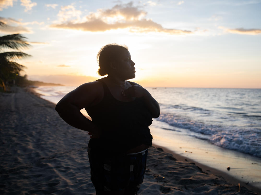 With the sun setting off the coast of northern Honduras, Ella Guity watches her daughters, Jirian and Eleny, swim in the warm Caribbean waters of the village of Rio Esteban, home to a group with African and indigenous roots known as the Garifuna. Ella had left years earlier for life in the big city, but the pandemic led her back home.