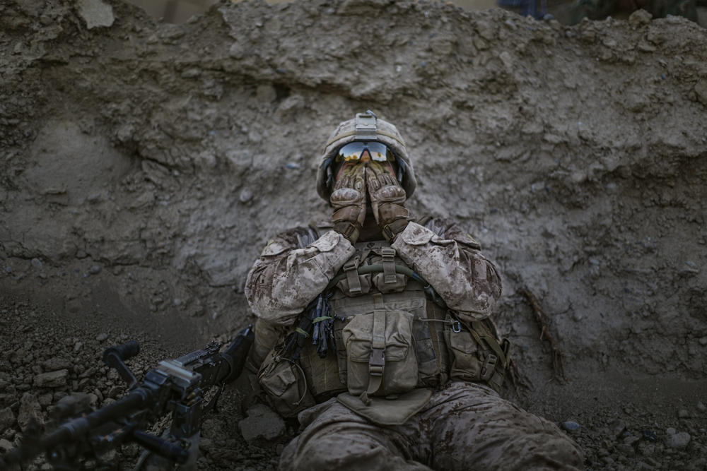 Marine Lance Cpl. Anthony Espinoza wipes sweat out of his eyes at the end of a patrol on a 100-degree day in Sangin, Helmand province, Afghanistan, May 2011.